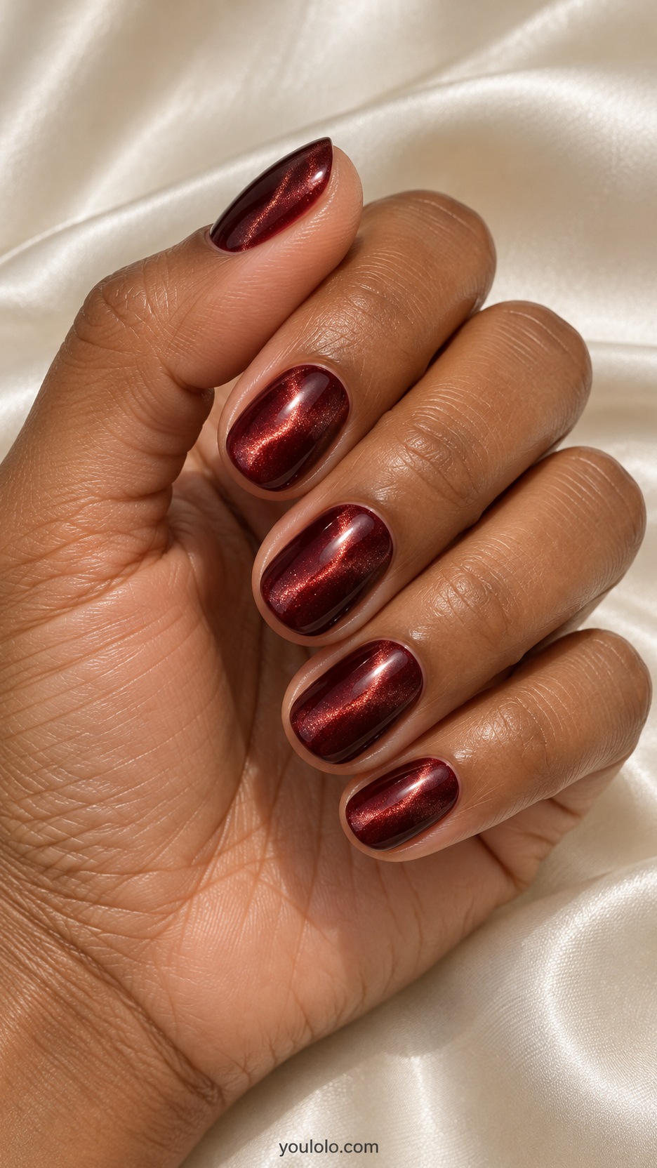 Short Red Cat Eye Nails: short rounded garnet magnetic nails curved glow along one side
