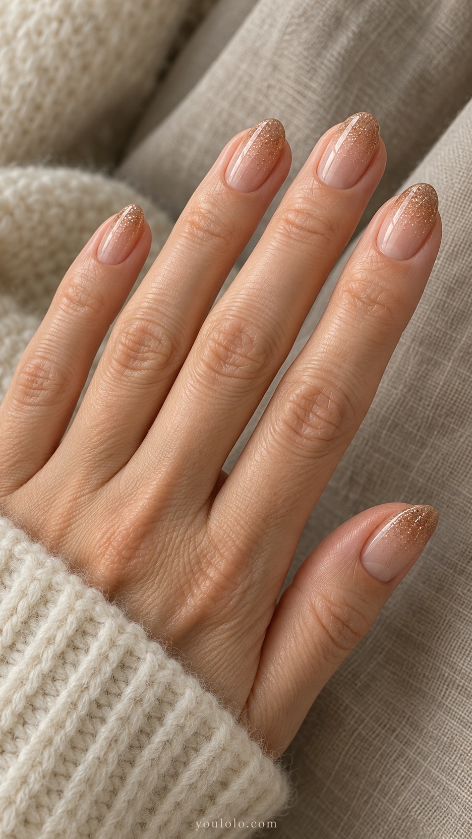 Short Almond Nail Designs: Bronze Tip Fade manicure on a naturally posed hand
