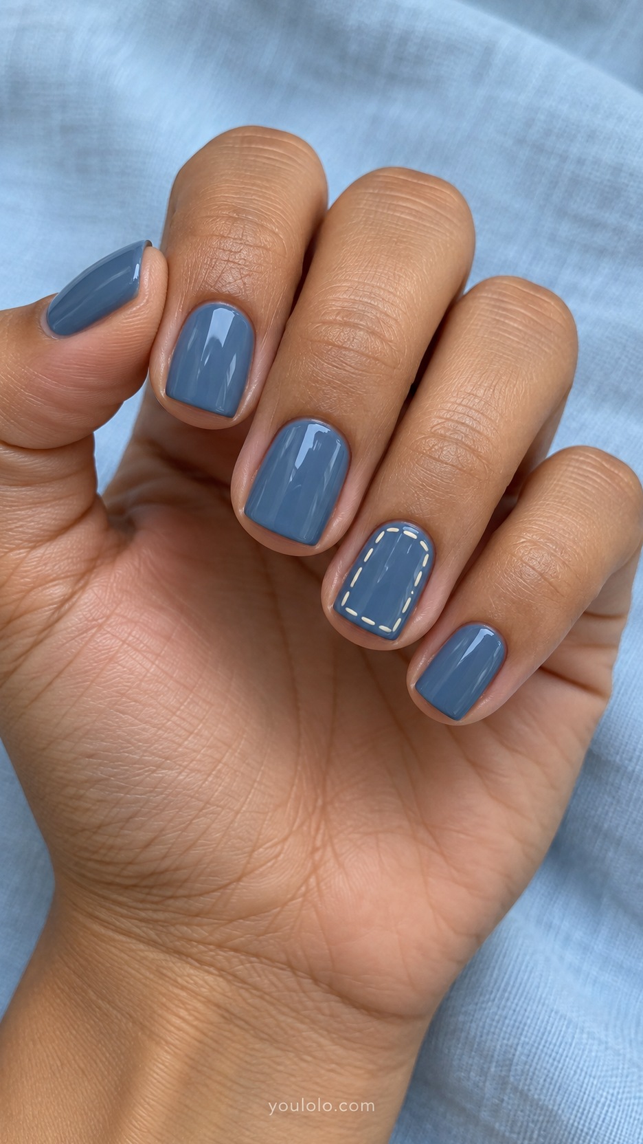 Short Square Nail Designs: Denim Blue Stitch Lines manicure on a naturally posed hand