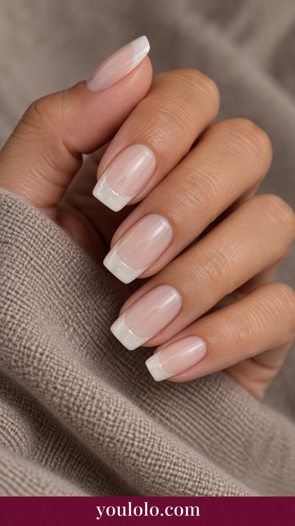medium soft square nude cream base with fine white microglitter French tips, evenly fine no chunky glitter on a naturally relaxed adult hand