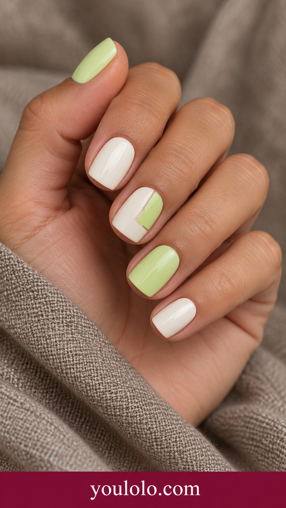 Lime White Blocks: short soft square nails alternating pale lime and ivory with one accent clean small offset geometric color blocks on a naturally posed adult hand