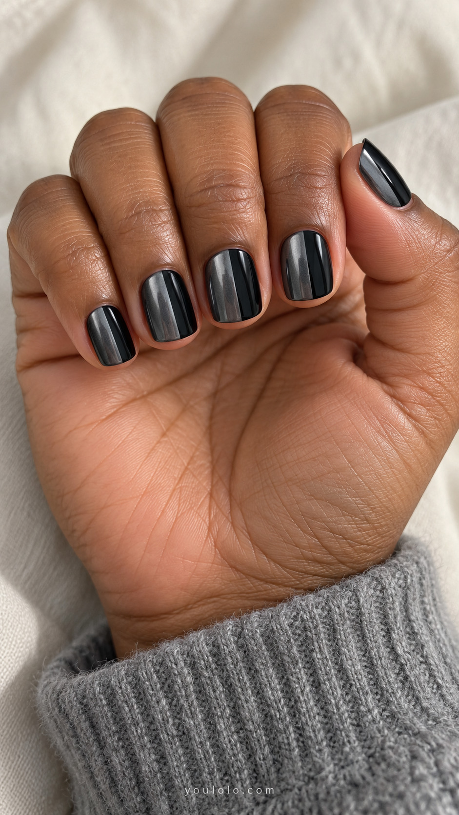 Short square nails divided off-center lengthwise, 70percent dark gunmetal chrome and 30percent glossy black, crisp boundary, no metallic stripe