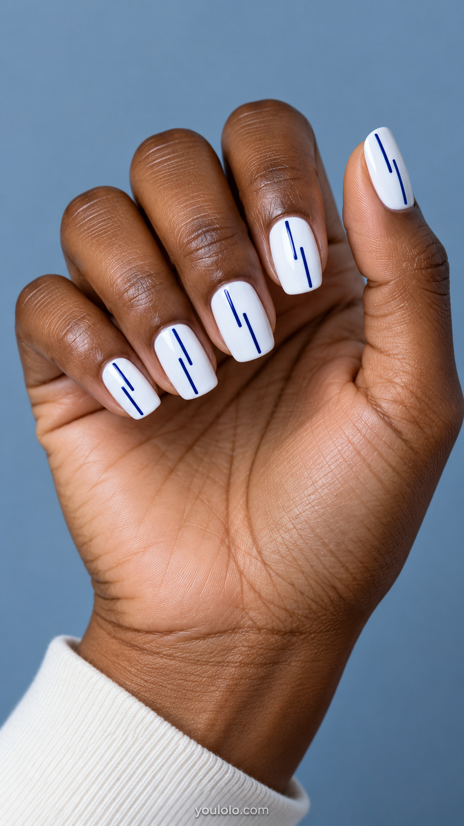 White square nails with two narrow broken cobalt stripes on each nail