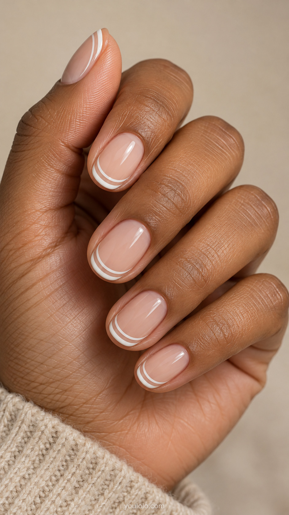 Short oval nails with two fine white French tip arcs separated by a narrow nude gap.