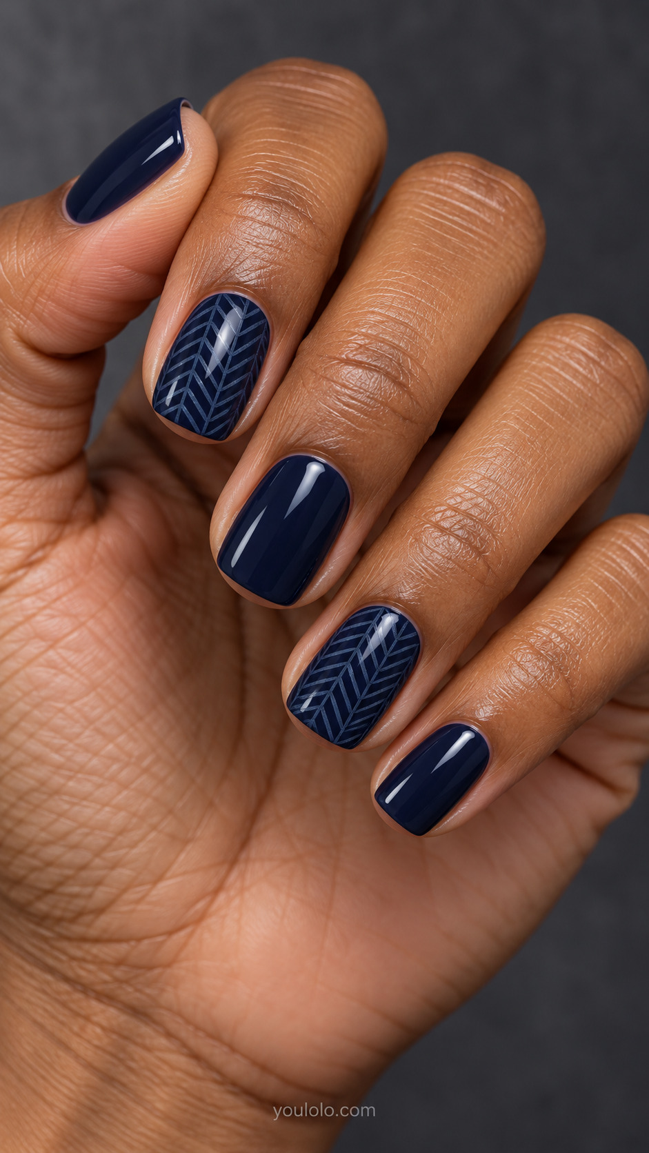 Midnight Blue Herringbone on a naturally posed hand, showing dark blue polish and detailed nail art