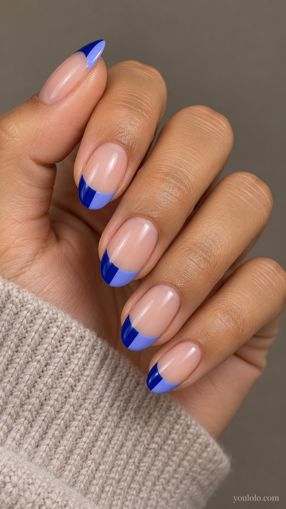 Split Sapphire and Periwinkle French on a softly gathered feminine hand with detailed sapphire blue manicure