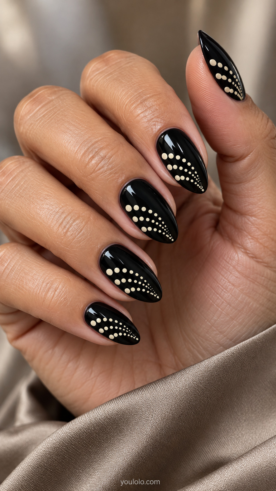 Glossy black almond nails with tapering ivory dot fans