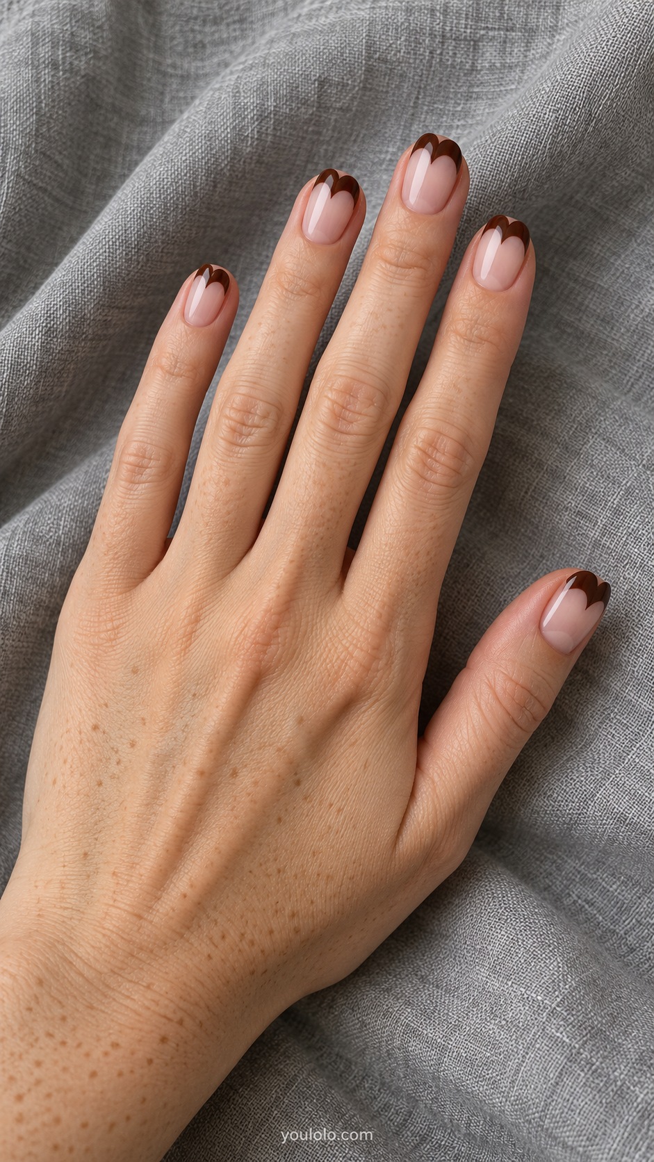 Short oval nails sheer pink with chocolate brown heart shaped French tips