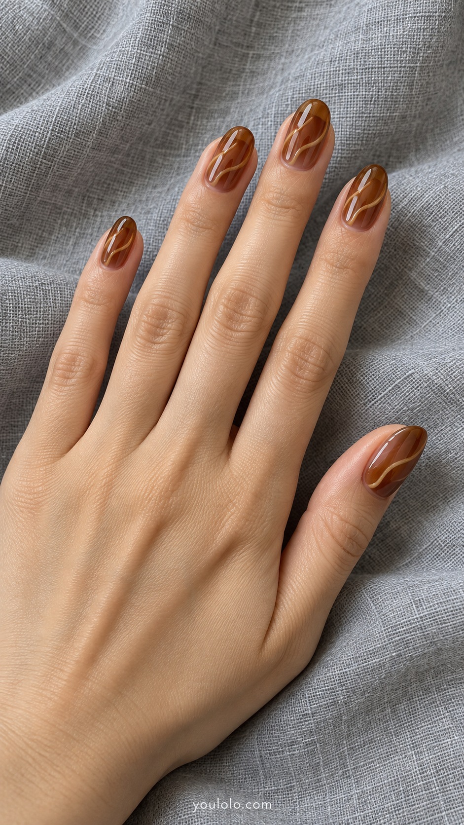Medium oval nails translucent amber brown jelly with subtle caramel colored curved ribbons