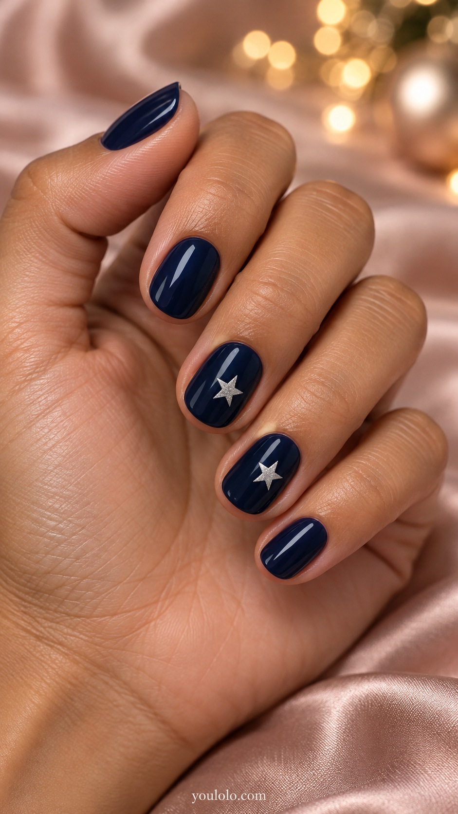 Short round midnight blue nails one small flat silver five pointed star on each ring and middle finger