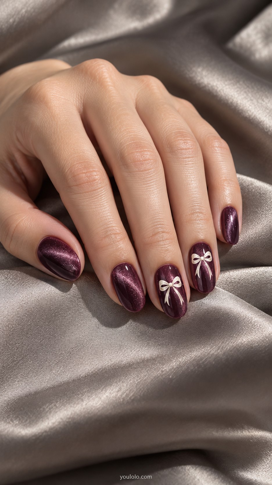 Plum Velvet with Tiny Bows: medium oval plum magnetic velvet nails, two accent nails with small flat ivory painted bow and fine tails
