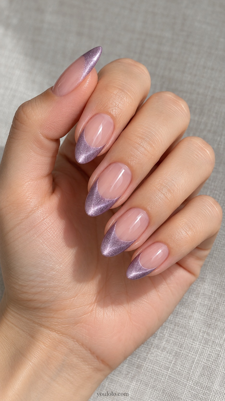 French Cat Eye Nails: medium almond nude beds lilac magnetic French tips with moderately deep curved smile