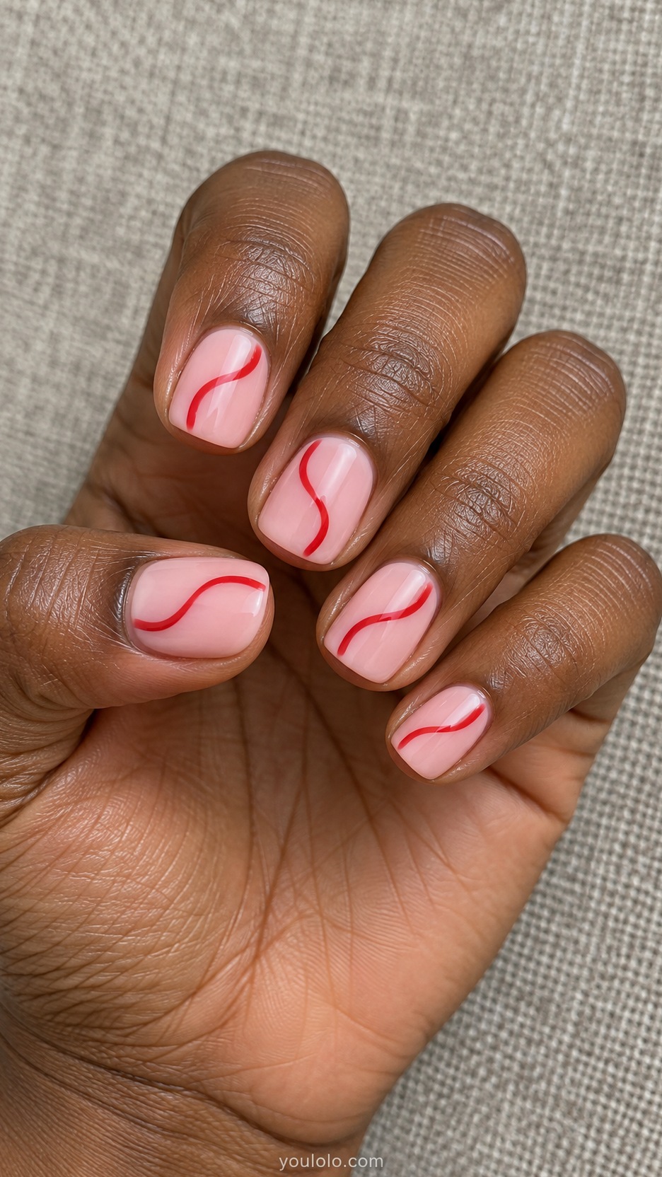 Short Artsy Nails: Pink and Red Wiggles manicure on a naturally posed hand