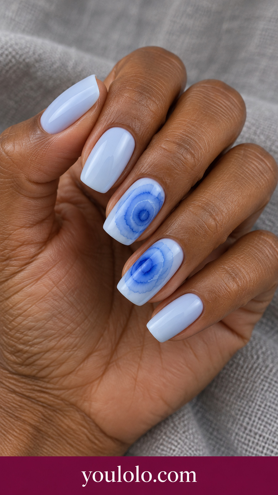 Ocean Ring Bloom: medium soft square ice blue nails two accents soft cobalt irregular concentric blooming rings on a naturally posed adult hand