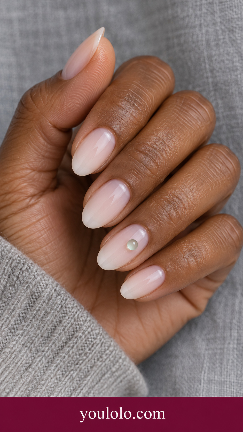 Mint Glass Bead: short almond milky nude nails ring nail one small transparent mint tinted gel bead near center low dome on a naturally posed adult hand