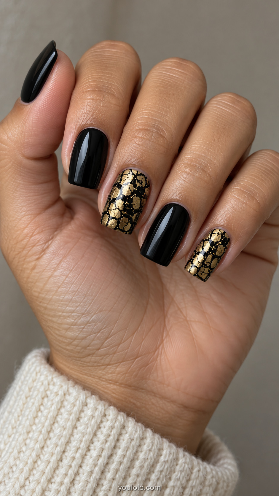 Black square nails with two flat gold-and-black crackle accents
