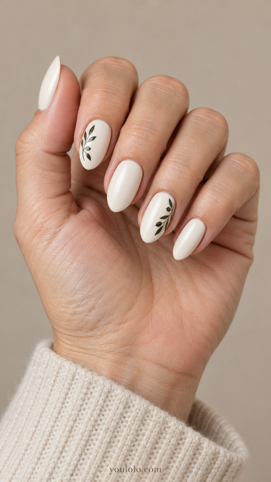 White almond nails with dark olive branches on the index and ring nails
