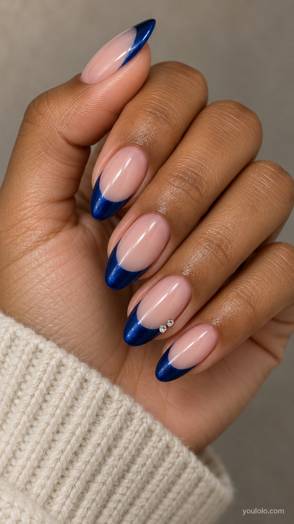 Sapphire French with Tiny Side Crystals on a softly gathered feminine hand with detailed sapphire blue manicure