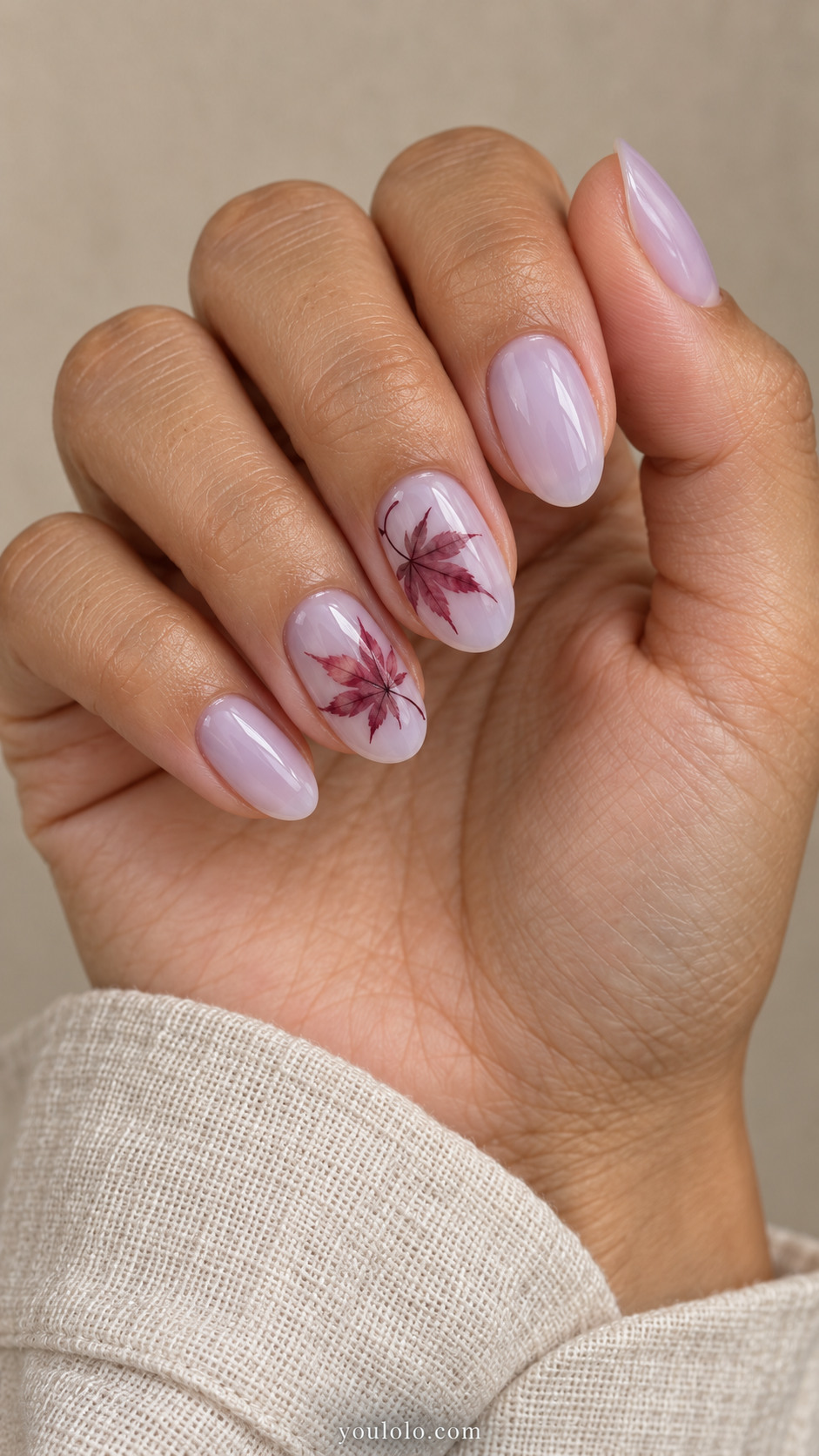 Medium oval nails with translucent milky lavender nails with delicate flat watercolor burgundy Japanese maple leaves with seven slender lobes on middle and ring; others lavender plain.