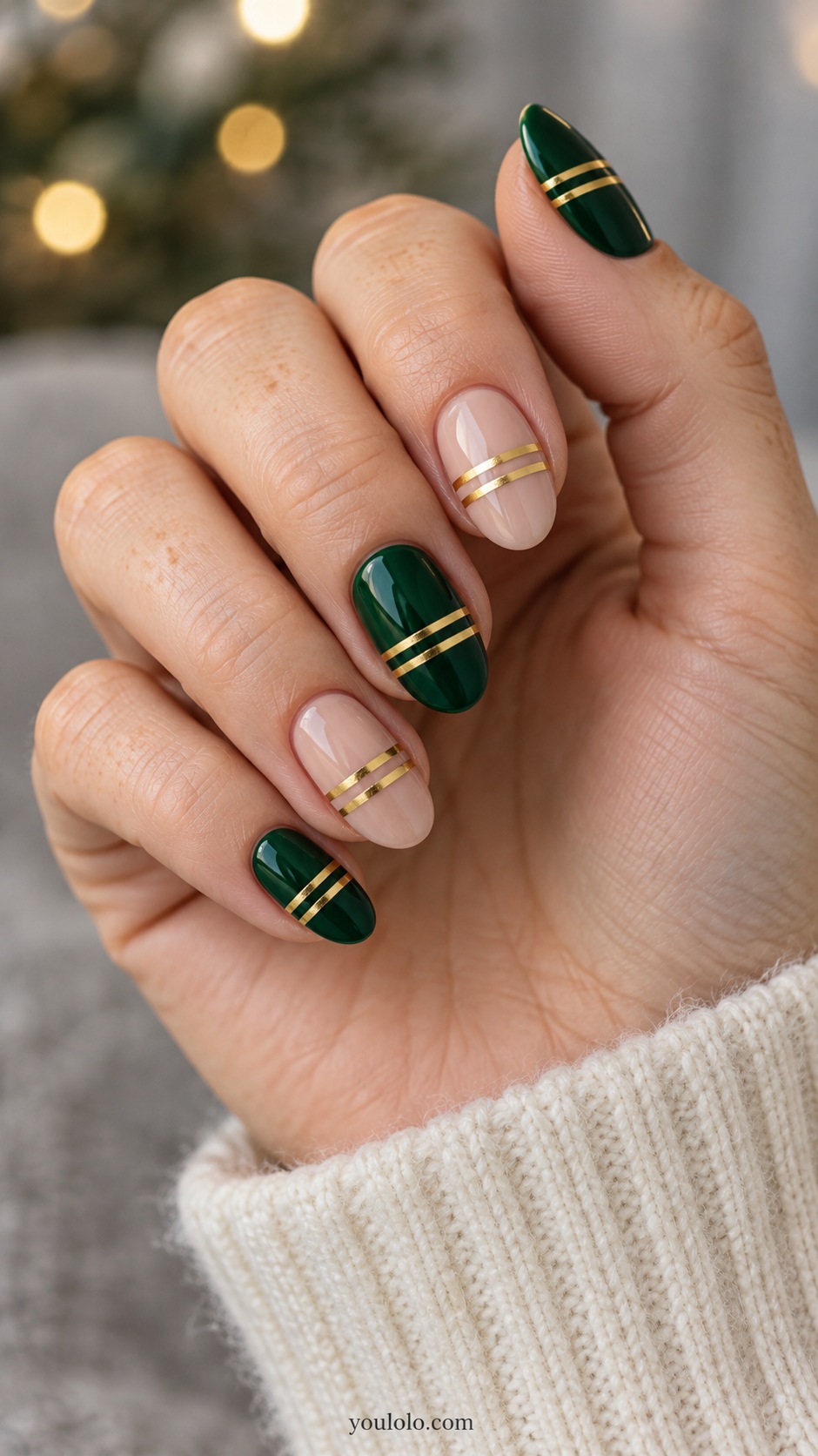 Medium oval alternating emerald and nude nails two fine gold transverse bands on every nail