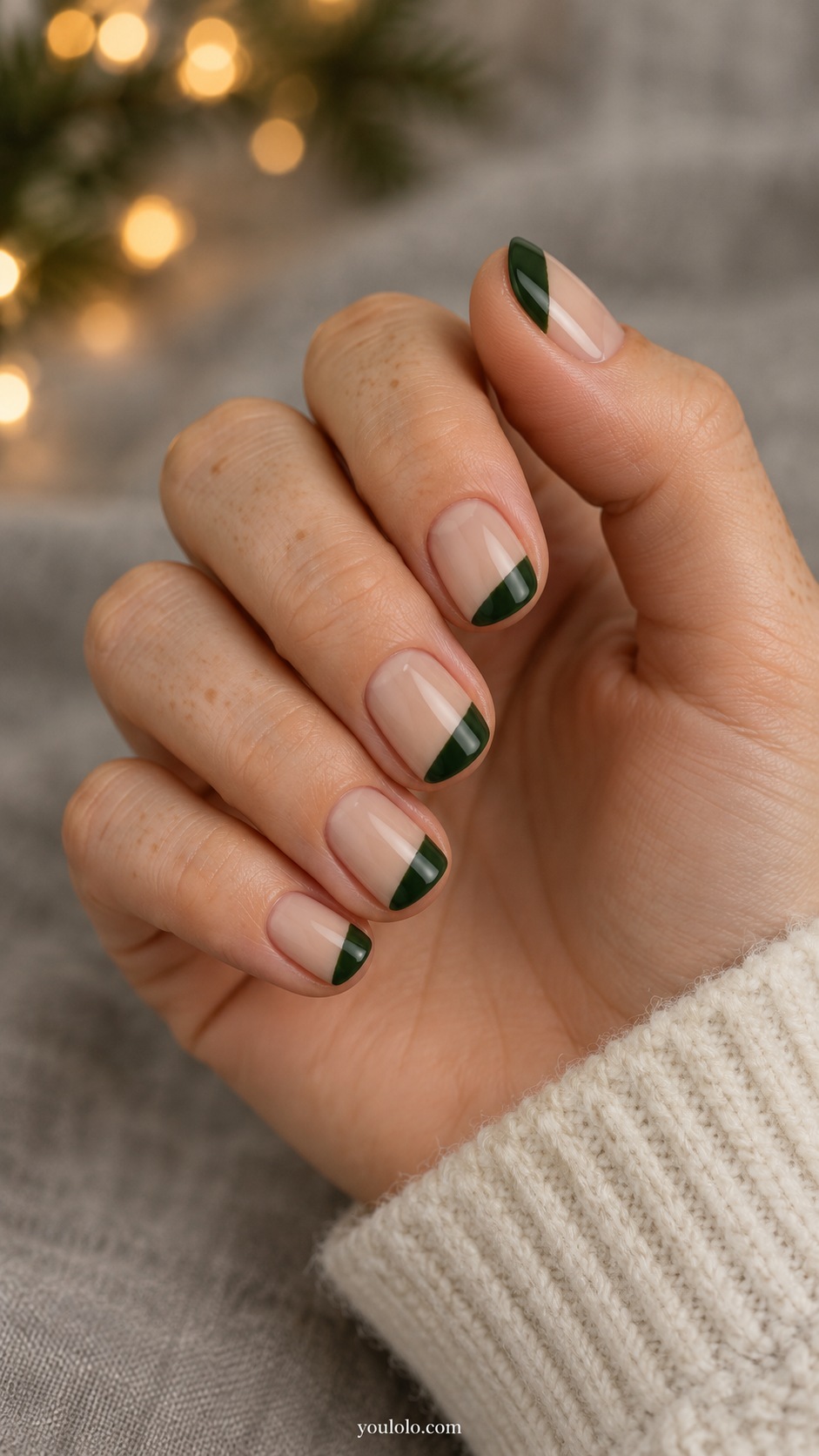 Short square nude beige nails one broad irregular forest green diagonal corner patch on each tip