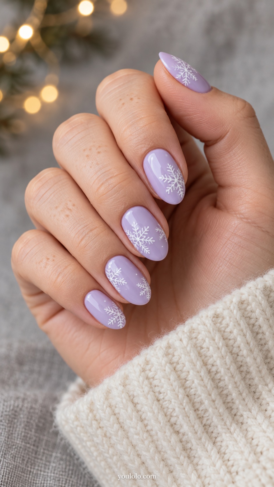 Medium oval pale lavender nails delicate flat white snowflakes cropped at side edges