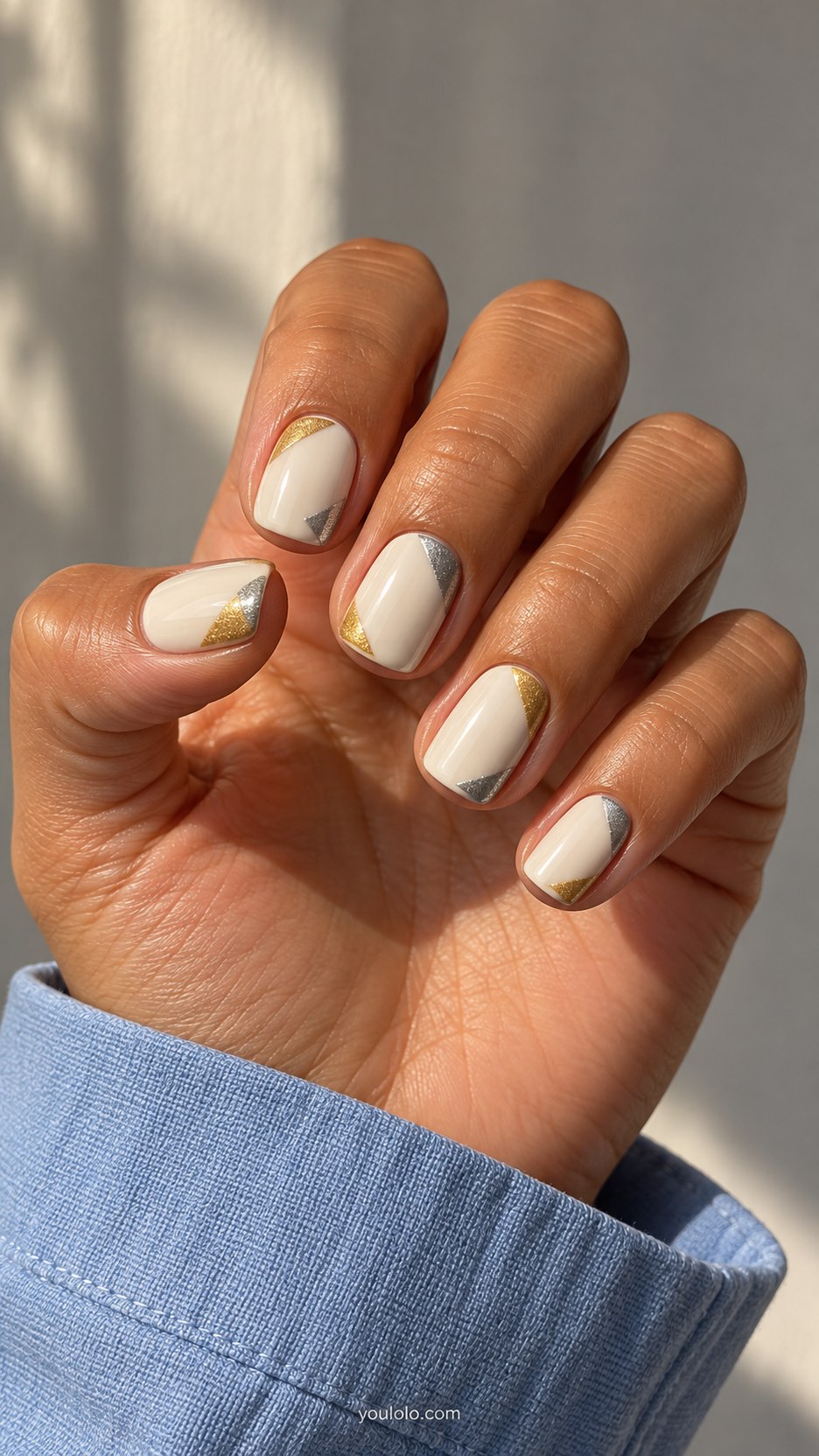 Metallic Corner Blocks: short squoval ivory nails, small triangular gold and silver blocks in opposite corners
