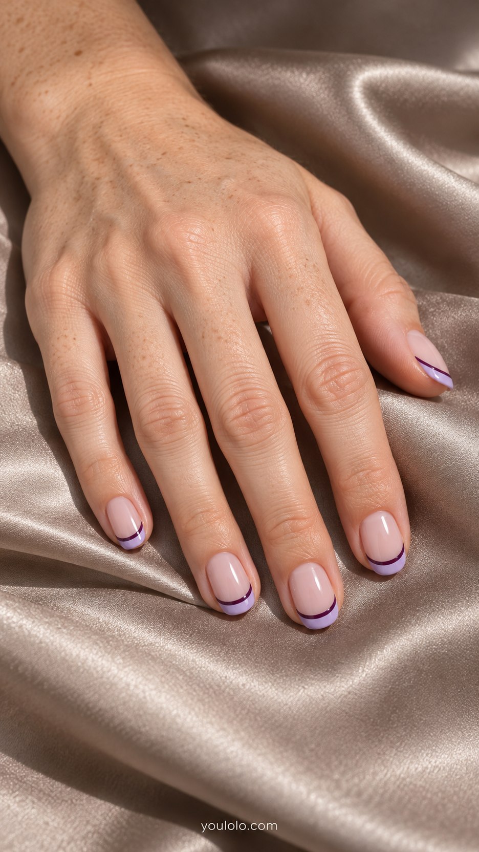 Lilac Cartoon French: short oval sheer nude nails, lilac tips outlined dark plum with tiny white highlight