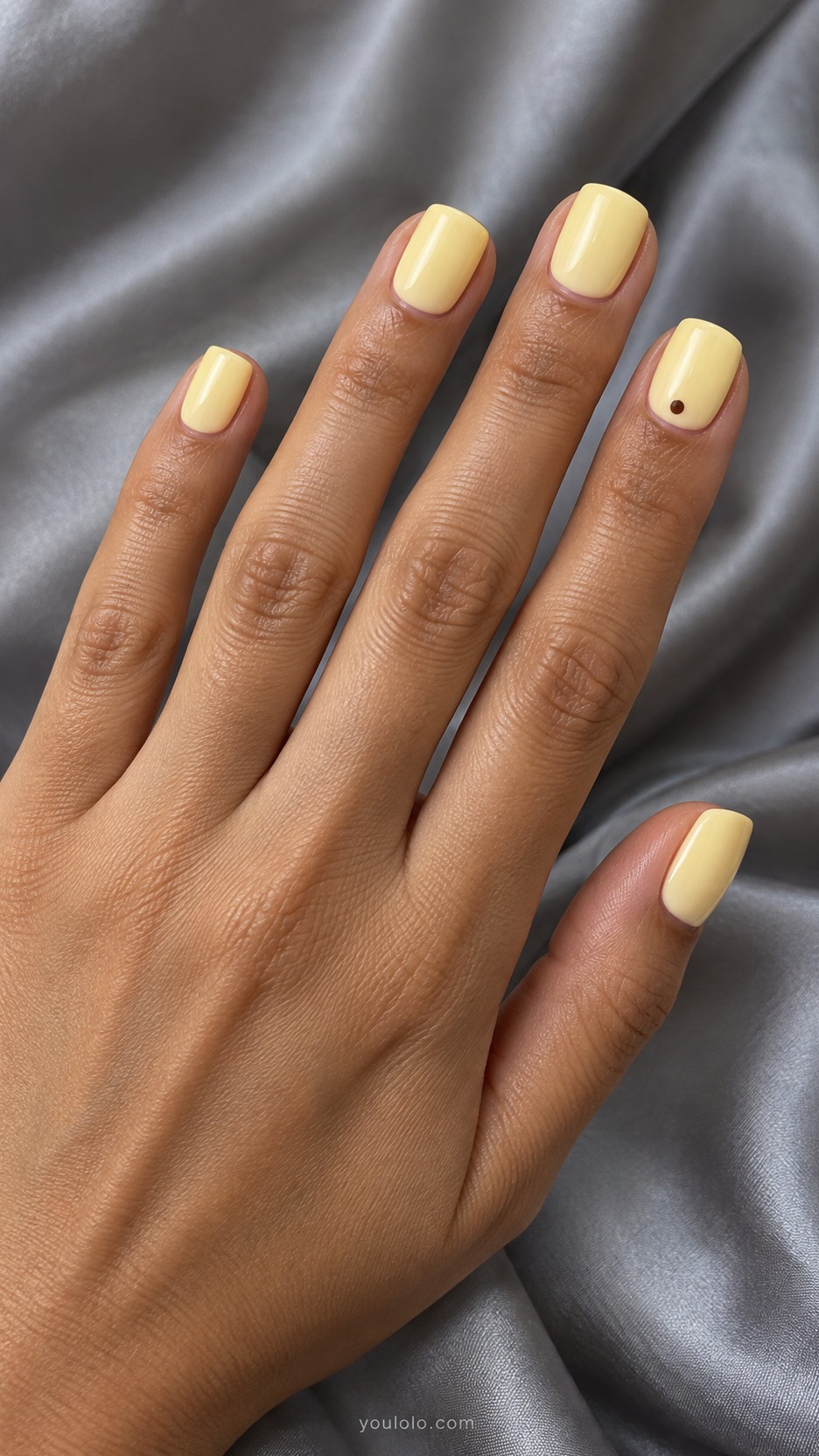 Short Press-On Nails: Butter Dot Accent manicure on a naturally posed hand