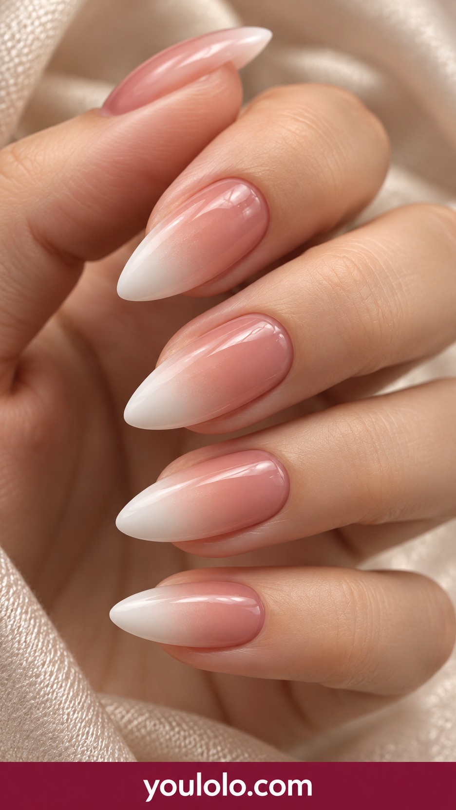 Medium almond blush base fading smoothly into soft white tips no other decoration on a naturally curled young adult hand