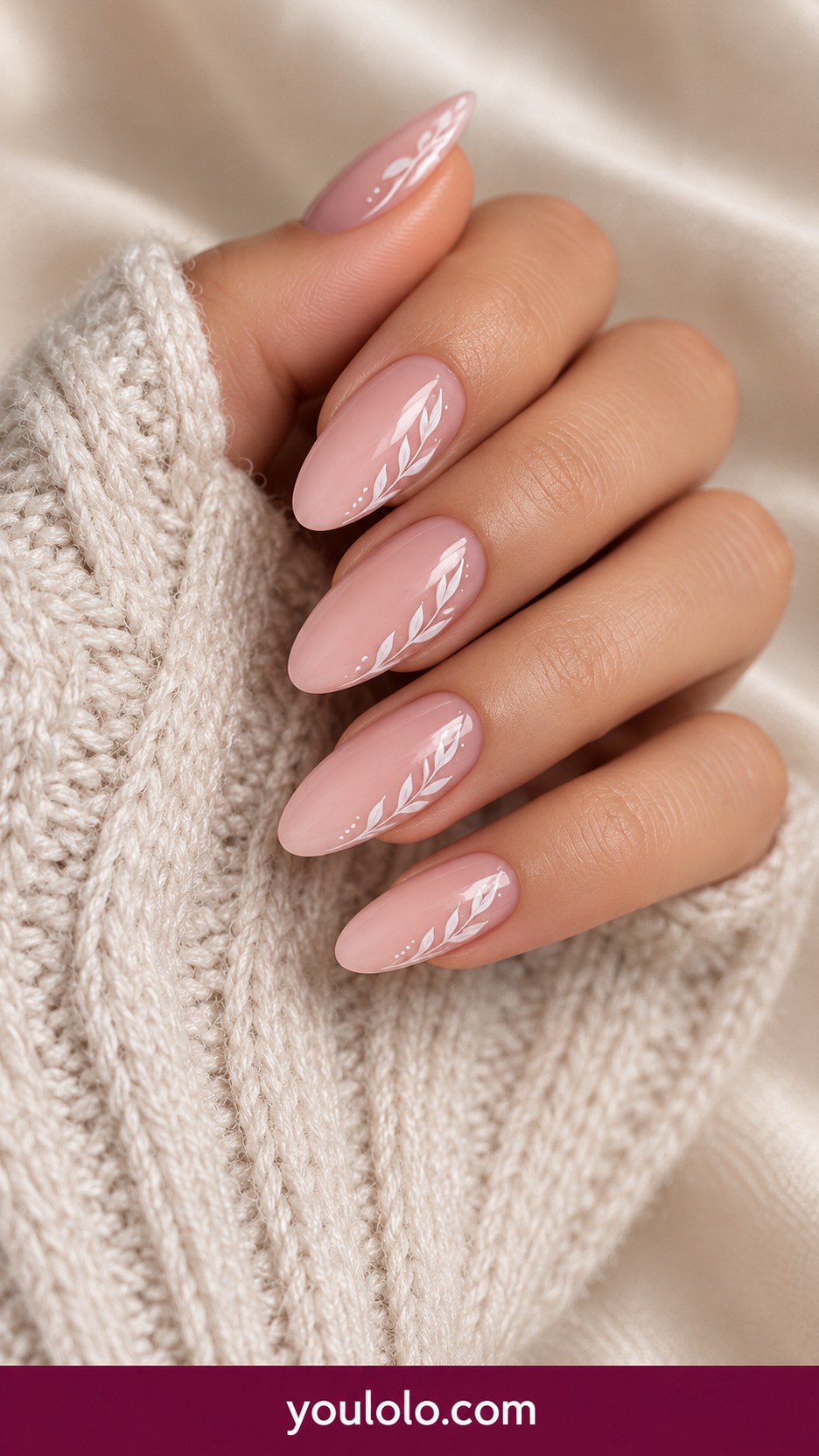 Medium almond nude pink nails with very fine white leafy vine painted along one side on each nail on a naturally curled young adult hand