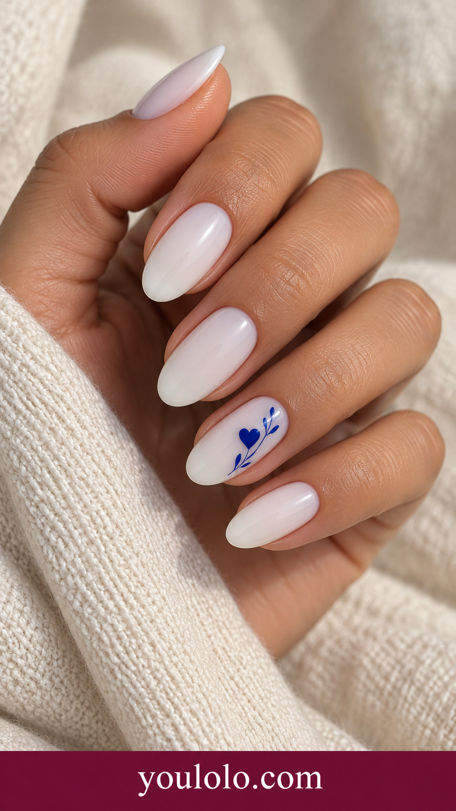 Blue Heart Porcelain: medium oval milky white nails one small cobalt heart with fine tiny cobalt leaf marks on ring nail on a naturally posed adult hand