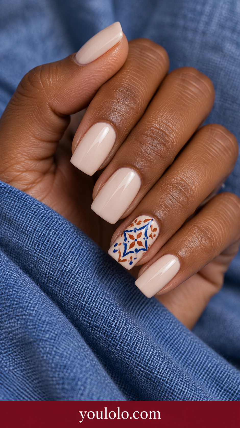 Terracotta Blue Tile: medium square creamy nude nails ring nail miniature terracotta and cobalt Mediterranean tile geometric motif on a naturally posed adult hand