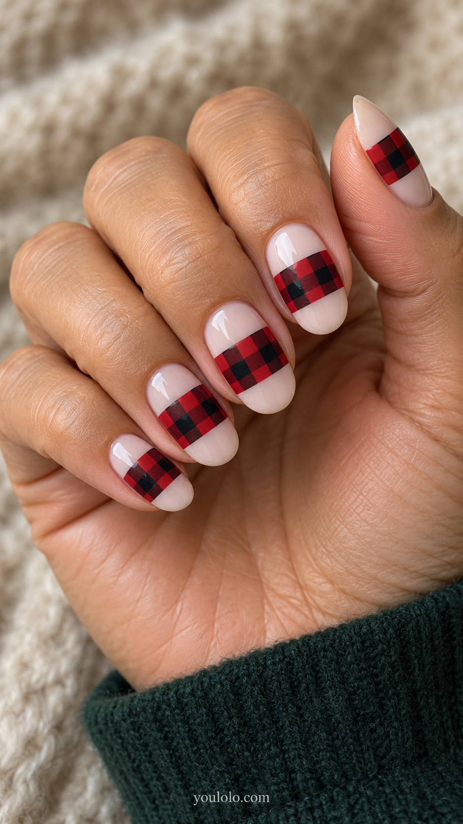 Milky nude oval nails with red-and-black checked bands across their centers