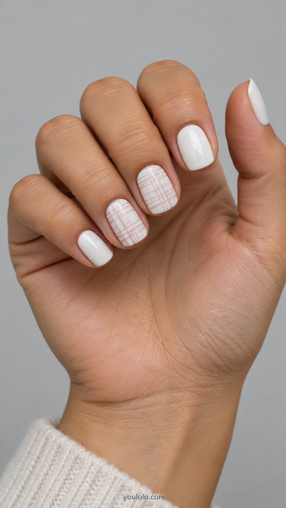 Short white squoval nails with pale blush crosshatch on two accent nails