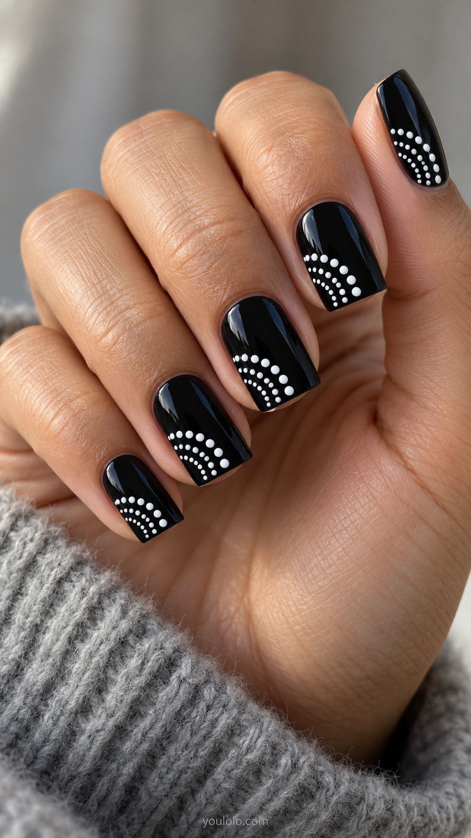 Medium square black nails with three nested quarter-circle arcs of uniform white dots from lower left corner, empty black elsewhere
