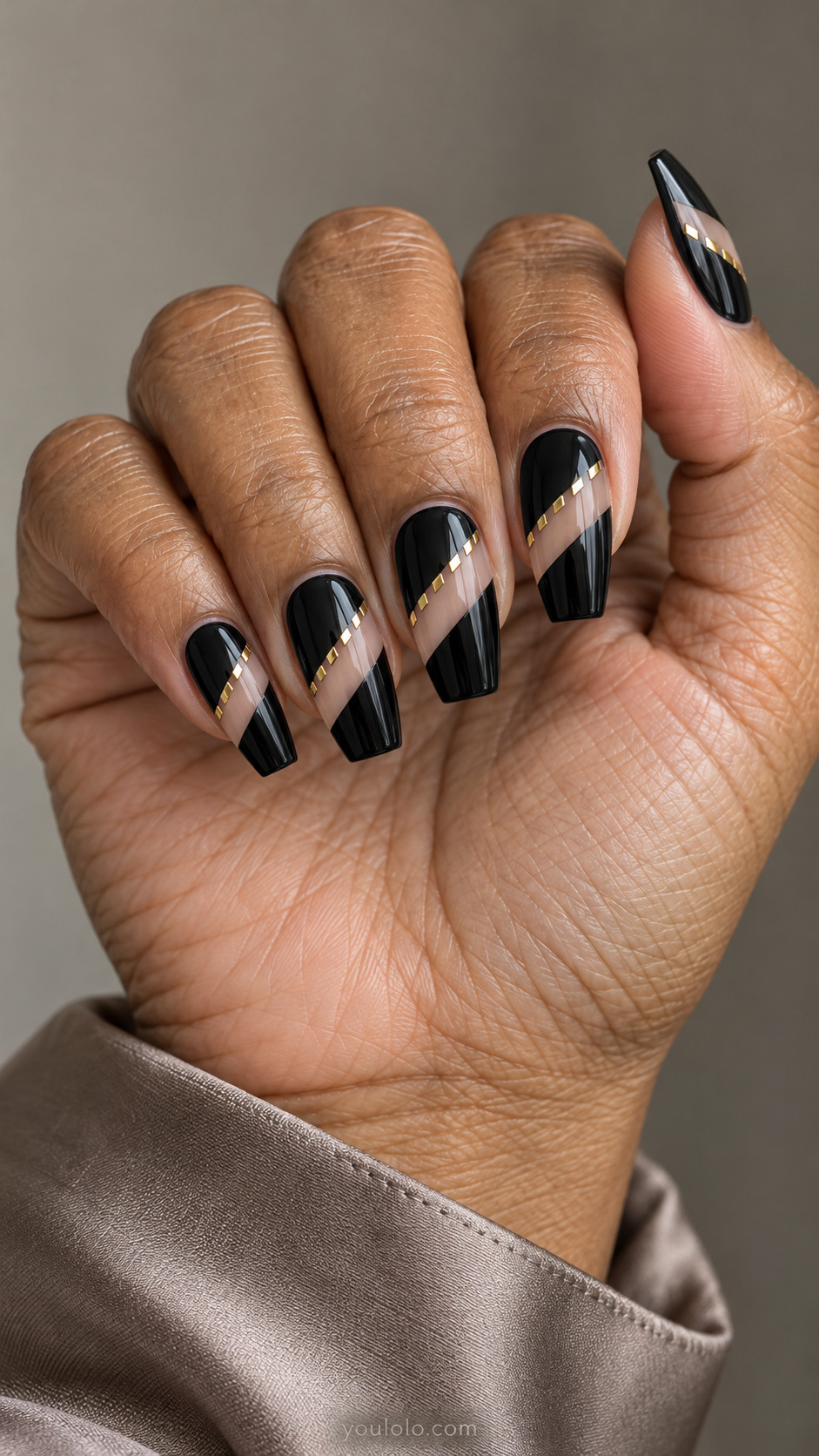 Black coffin nails with diagonal nude windows edged in tiny gold dashes