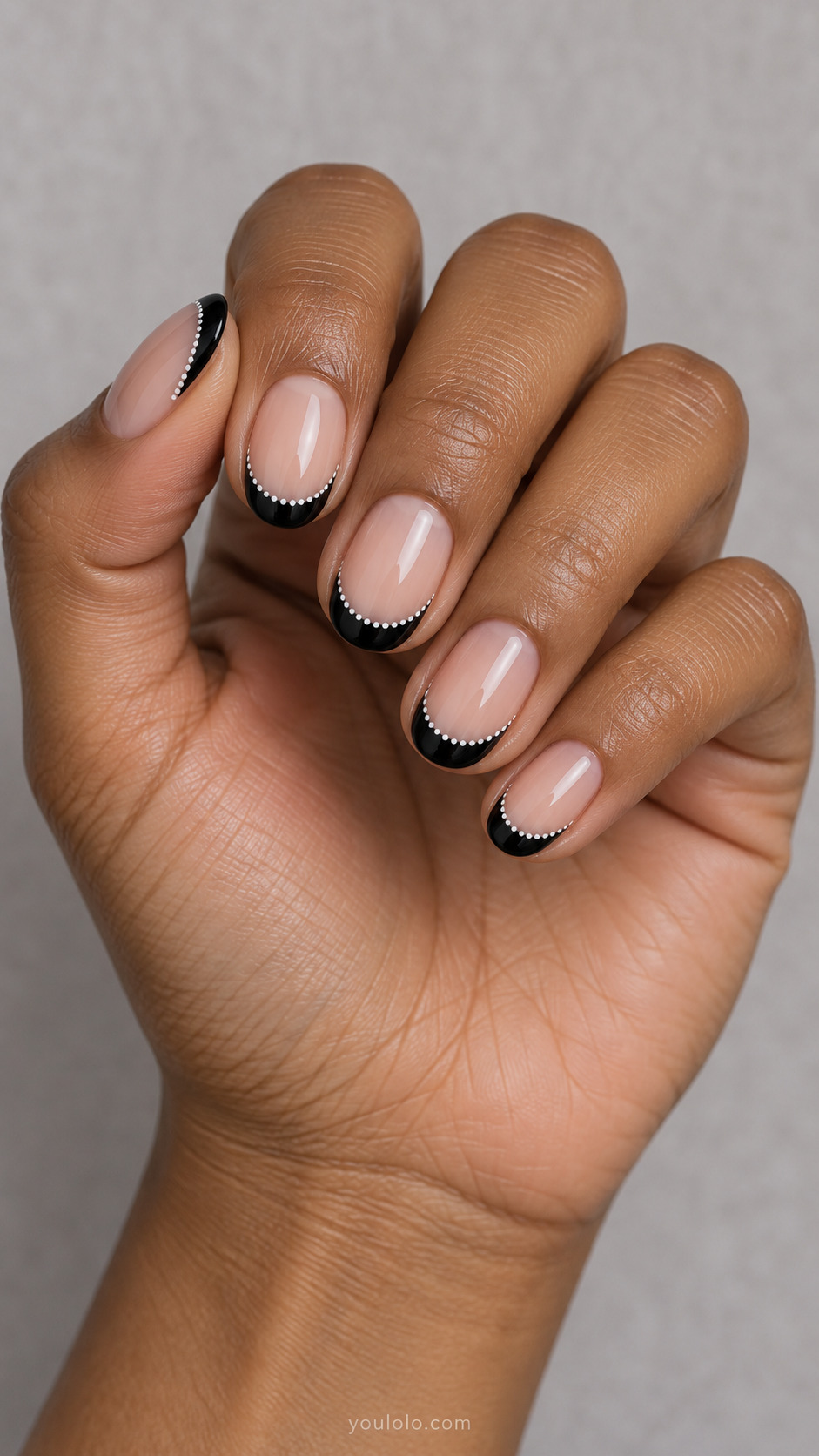 Dotted White Border on Ink on short oval nails with a nude base