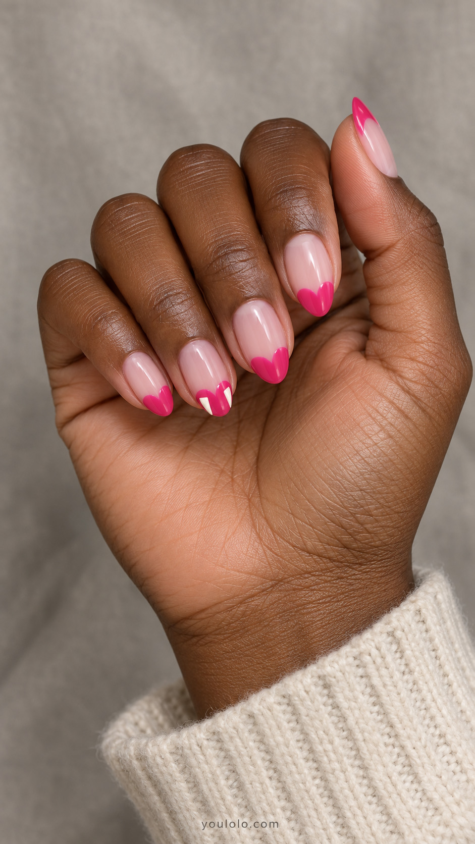 Pink heart-shaped French tips with white fangs on one accent nail