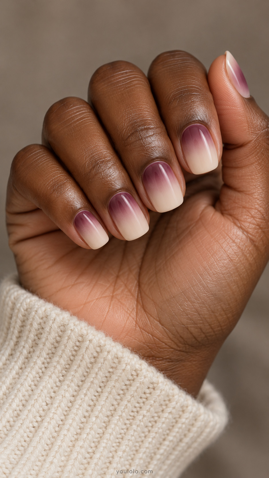 Short beige nails with soft plum shading near the cuticles