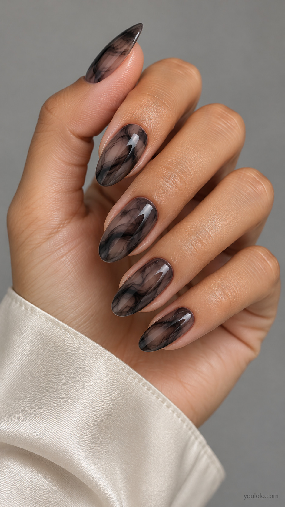 Translucent smoky black almond nails with layered charcoal wisps