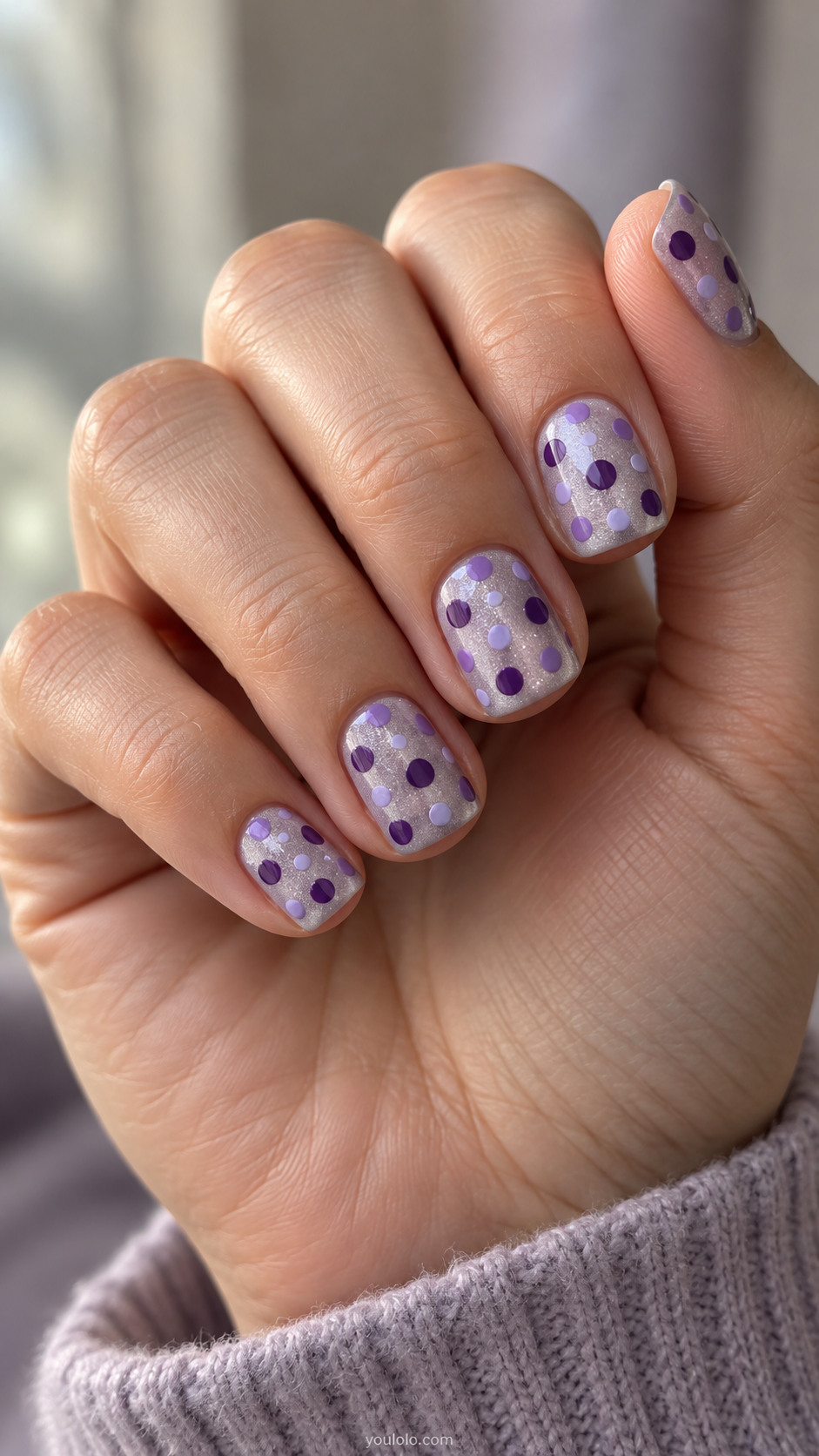 Short silver-lilac shimmer nails with separate opaque purple dots.