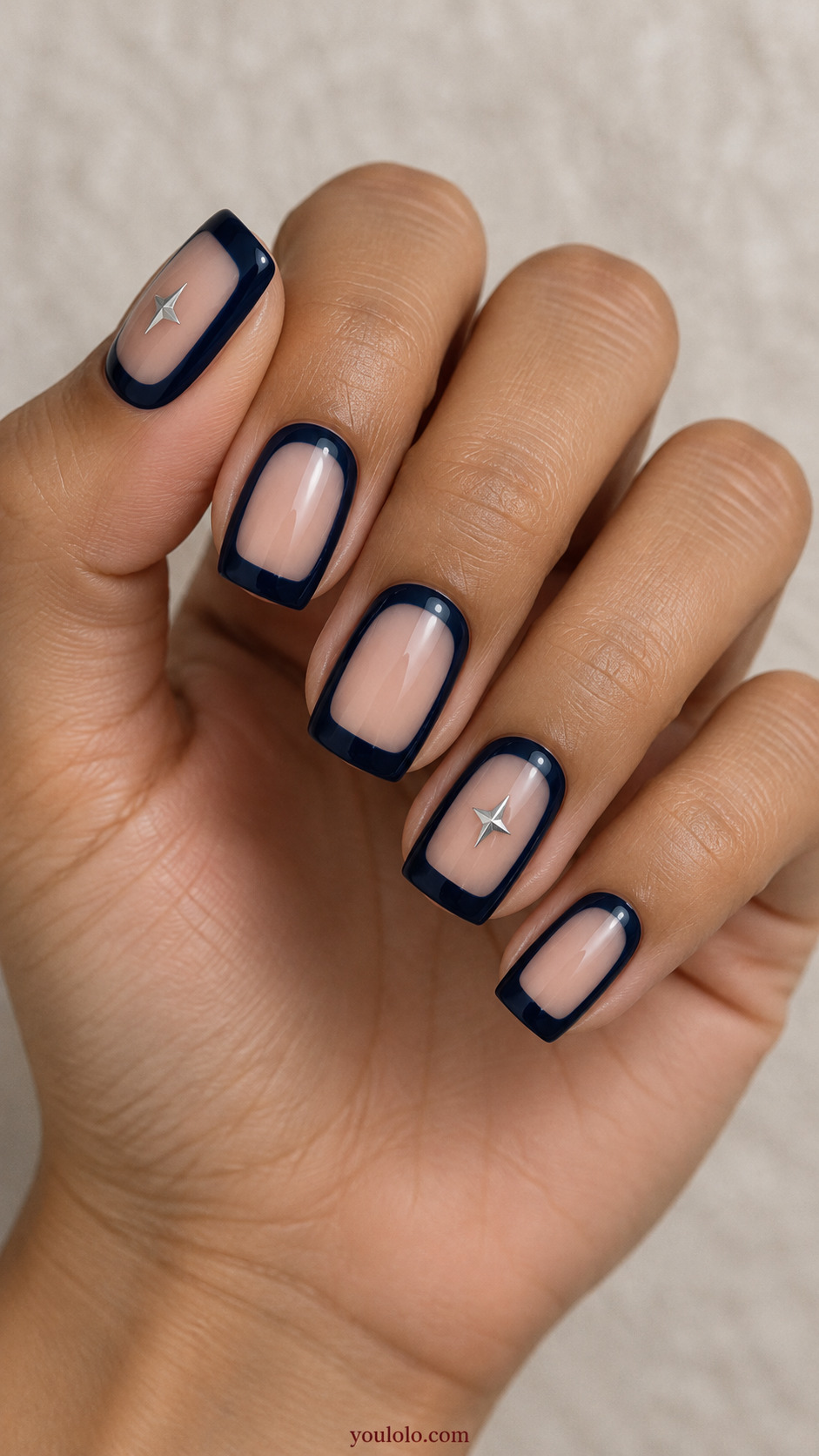 Silver Star Cutouts on a Midnight Frame on a naturally posed hand, showing dark blue polish and detailed nail art