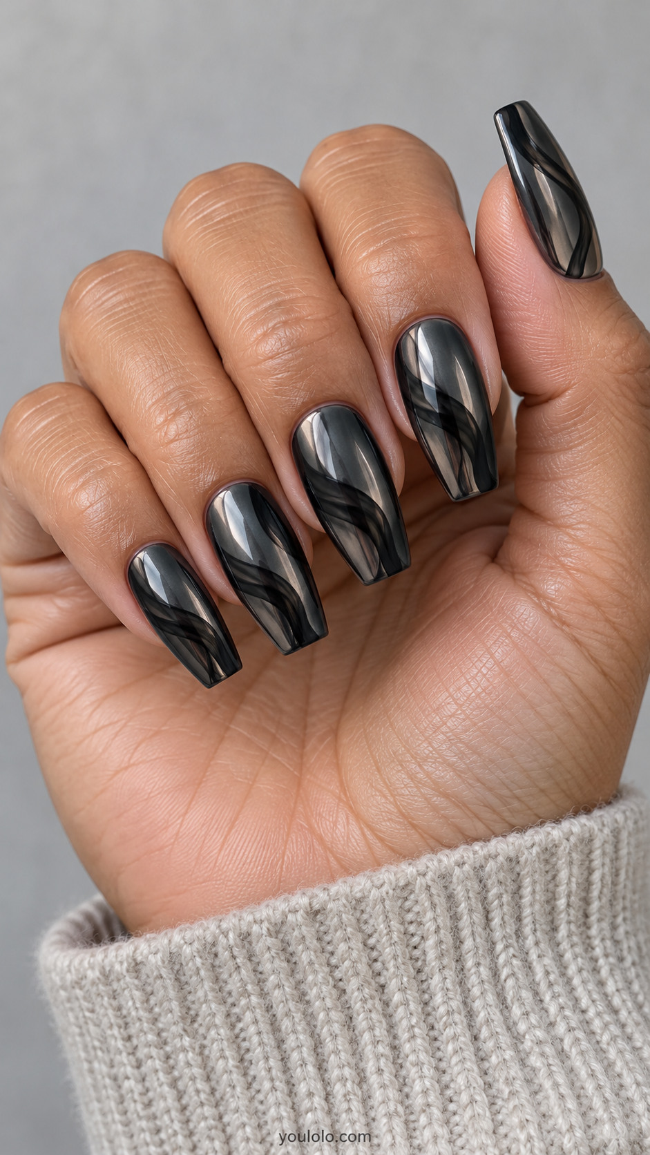 Medium coffin dark mirror gunmetal nails with broad sheer-black smoky swoops diagonally across surface, not thin silver lines