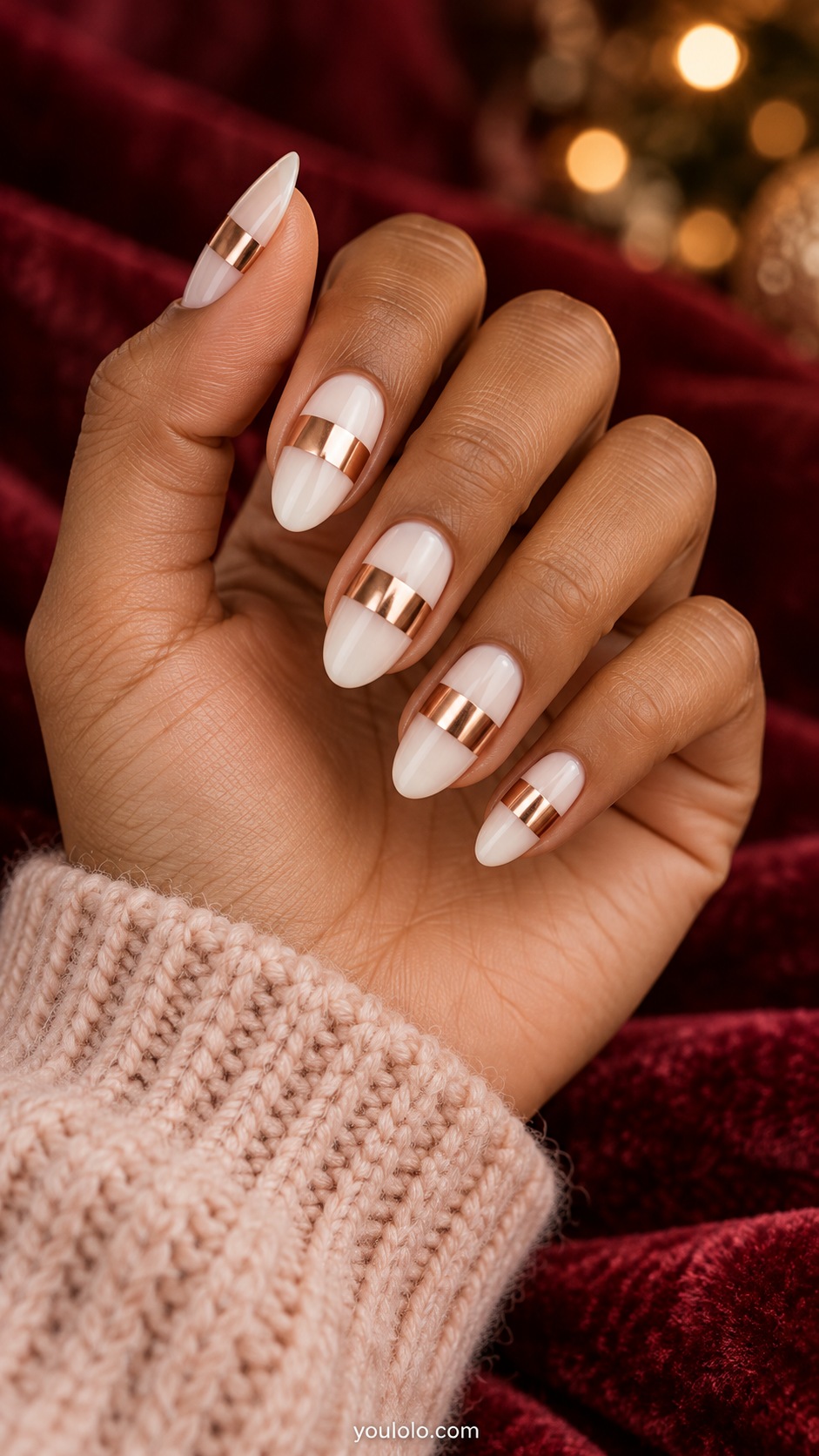 Medium almond milky white nails one broad rose gold chrome transverse band across middle