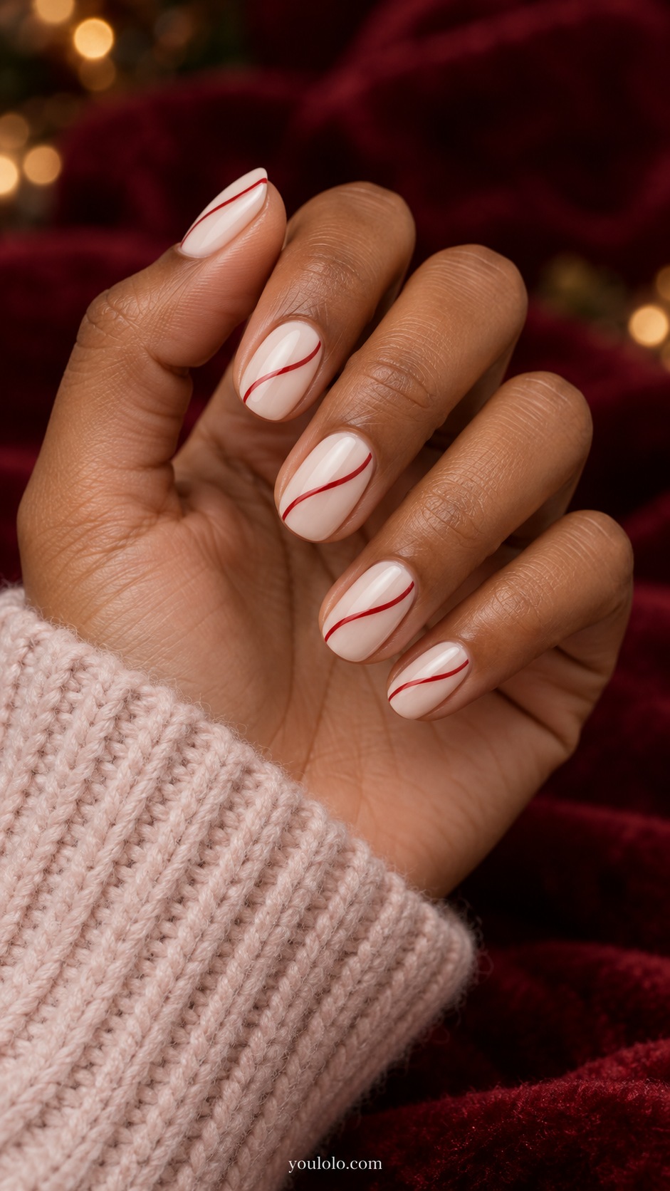 Short oval ivory nails single thin red slightly wavy diagonal line on each nail no bows