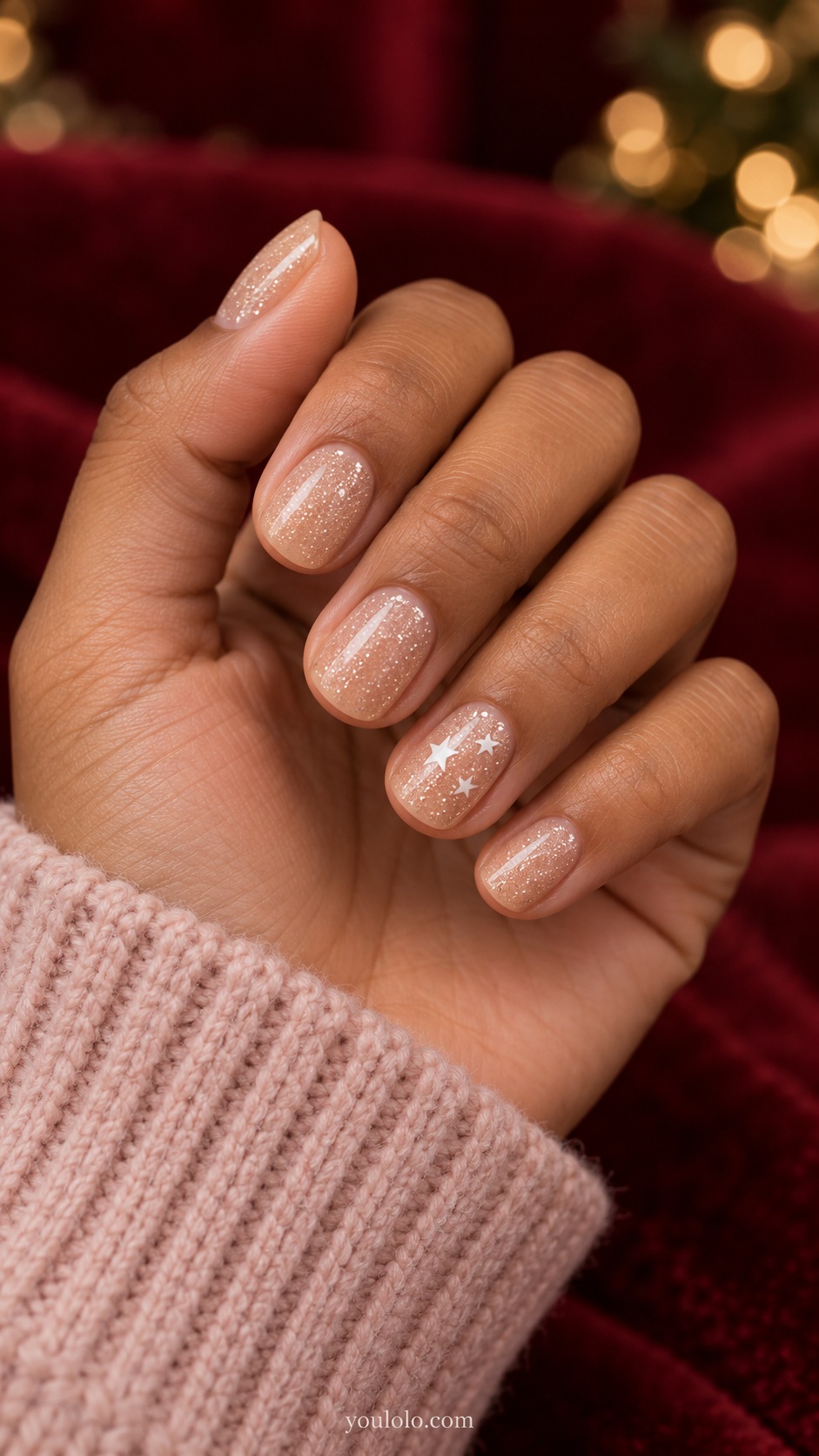Short round sheer beige nails fine champagne glitter with three small white five pointed stars on ring nail