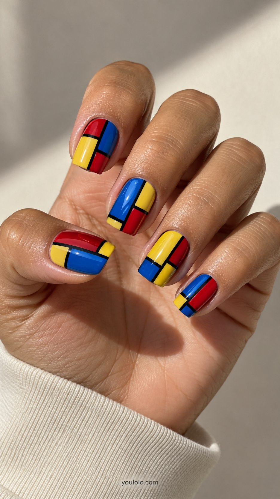 Primary-Color Panels: medium square nails, red blue yellow block panels separated by crisp black comic borders
