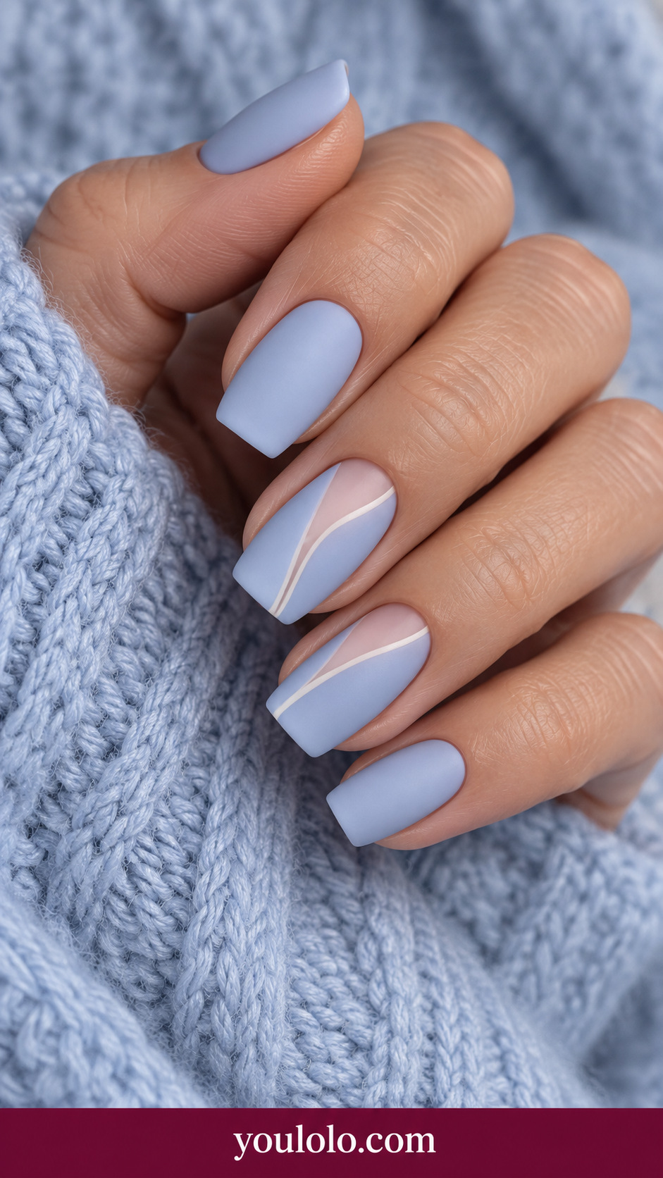 medium square dusty pale blue nails diagonal sheer nude window on two accents with very fine ivory outline on a naturally relaxed adult hand