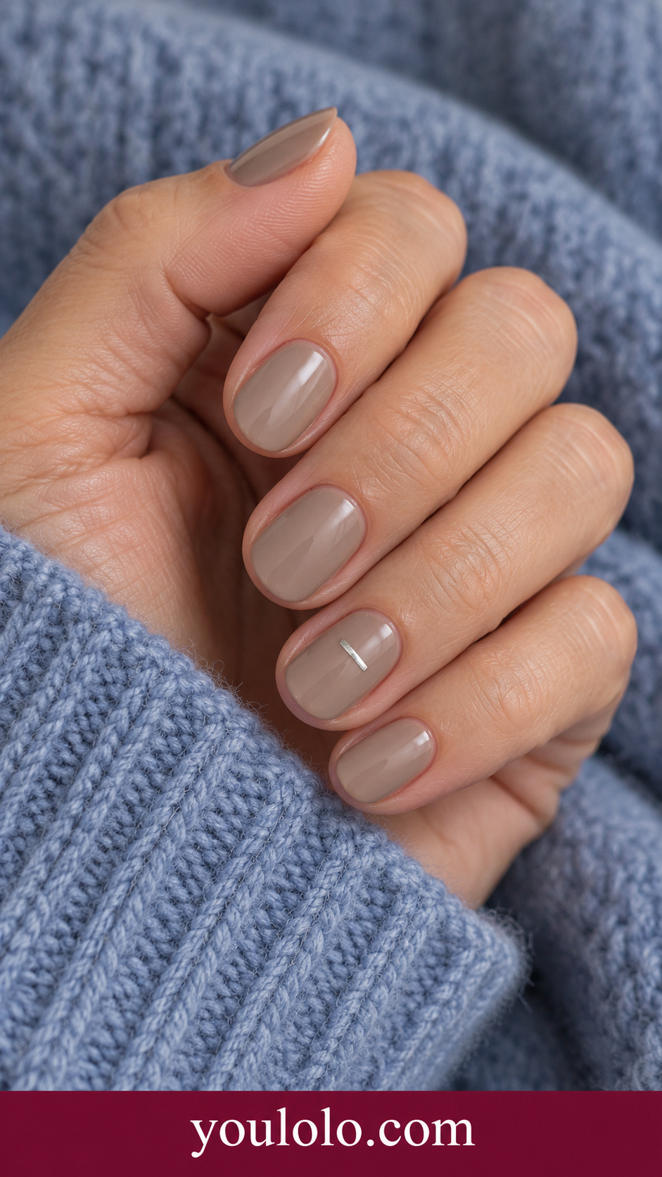 Silver Short Dash: short oval taupe cream nails one tiny flat painted silver horizontal dash near center of ring nail on a naturally posed adult hand